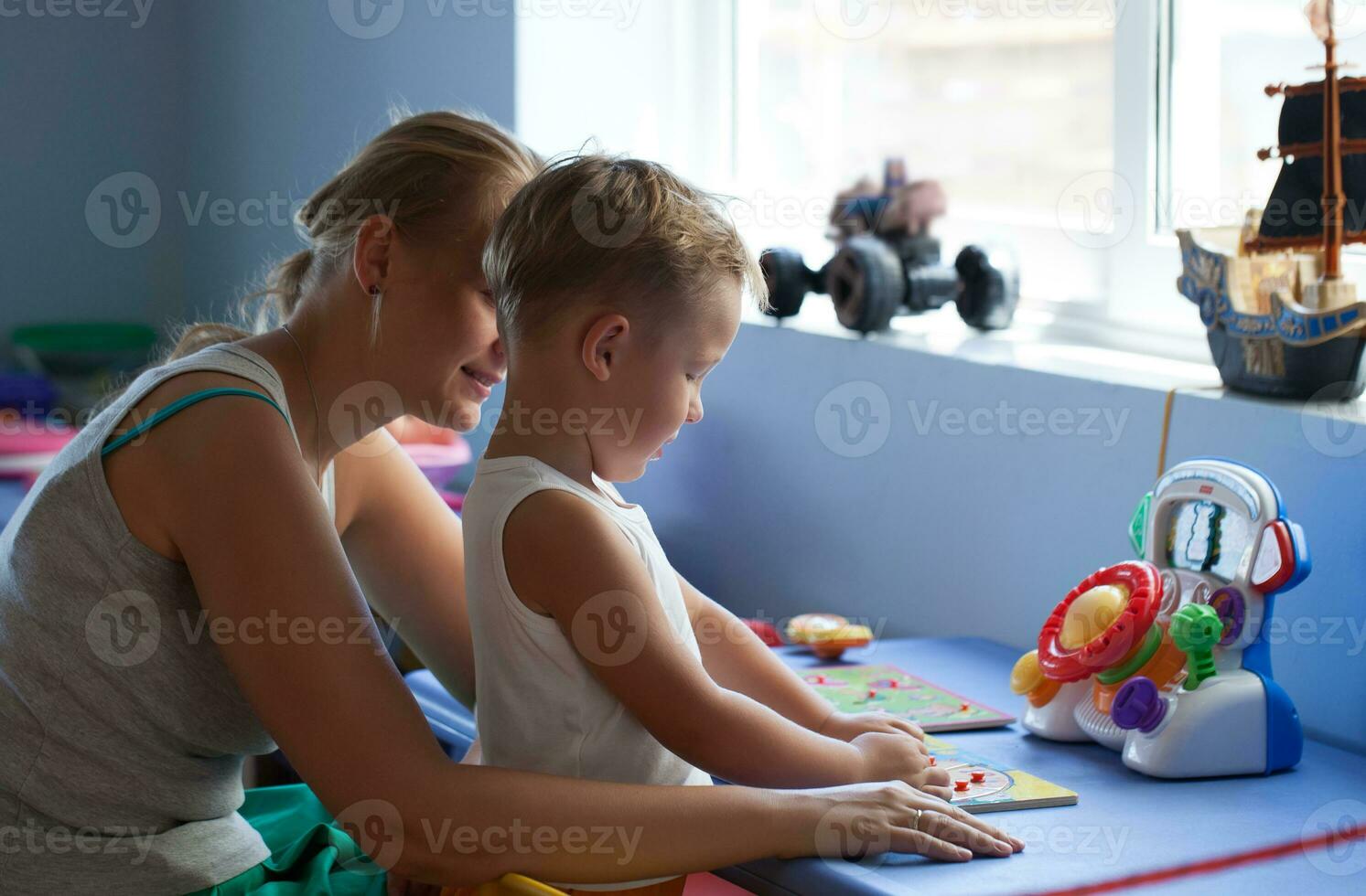 Mother playing learning game with son photo