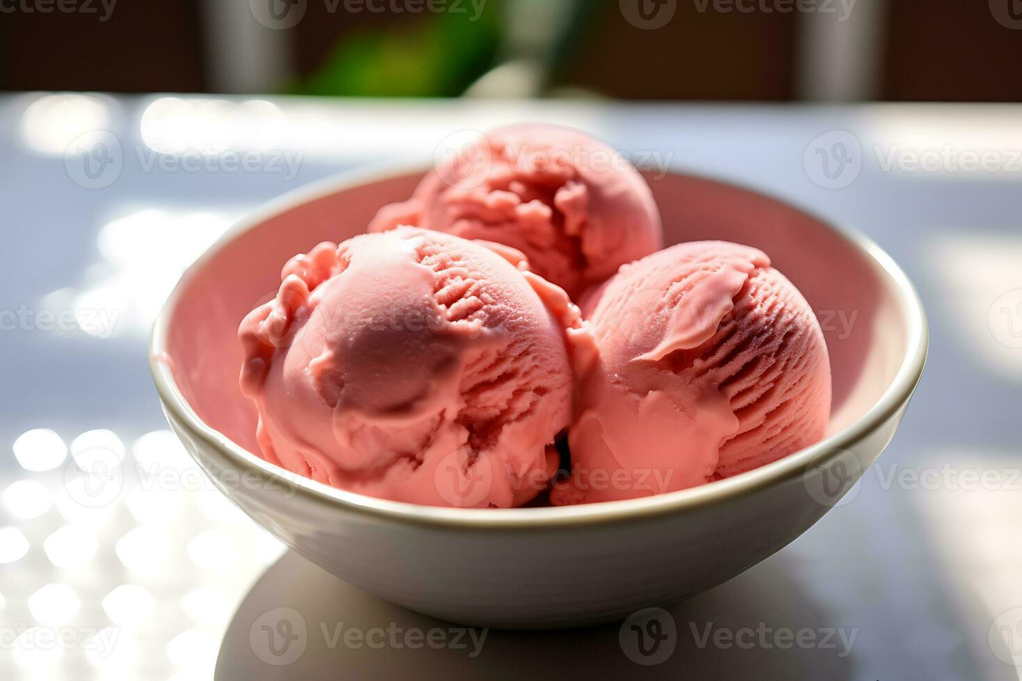 Closeup shot of a bowl with scoops of pink ice cream photo