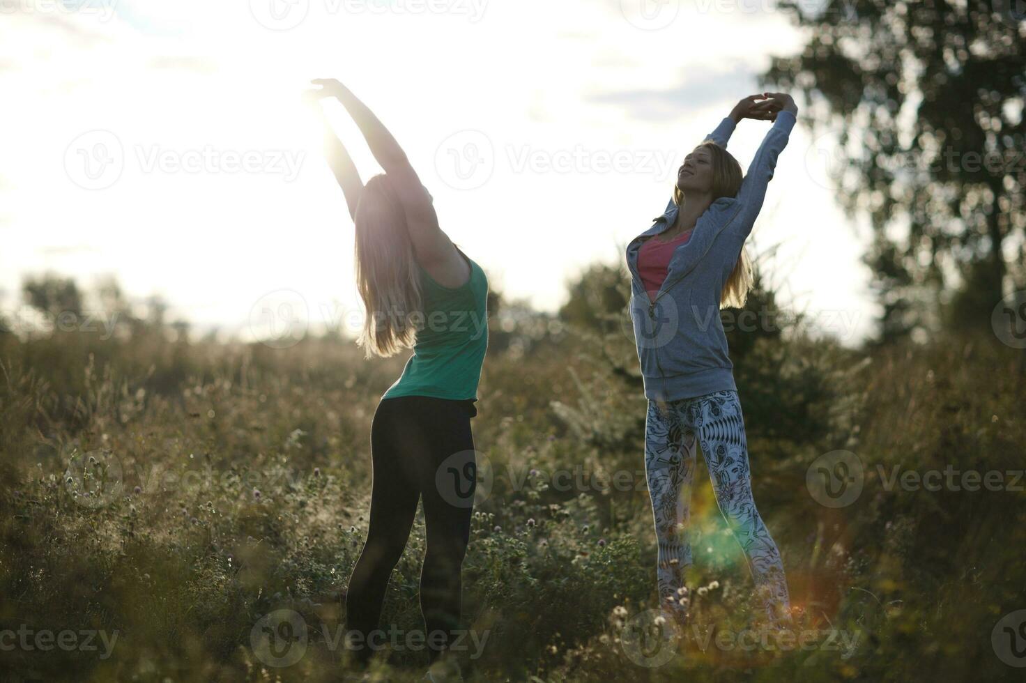 Two young women working out in the garden photo