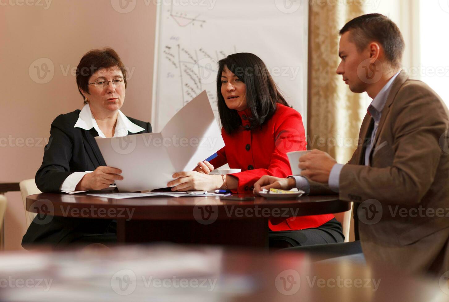 Businesspeople having a meeting over coffee photo