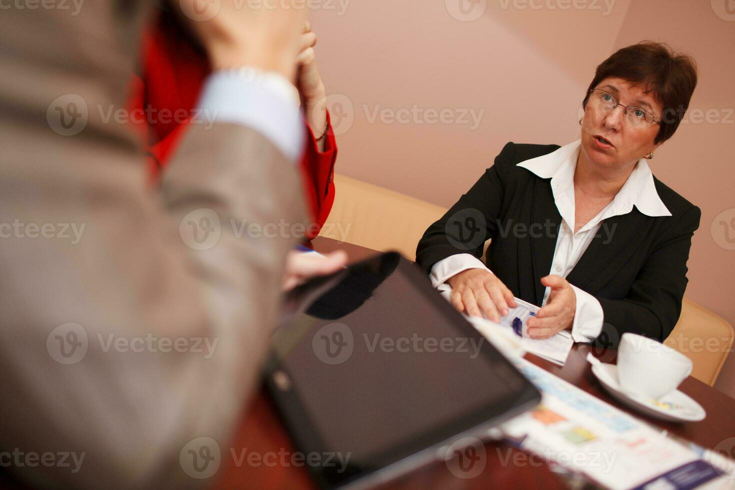Businesswoman explaining something in a meeting photo