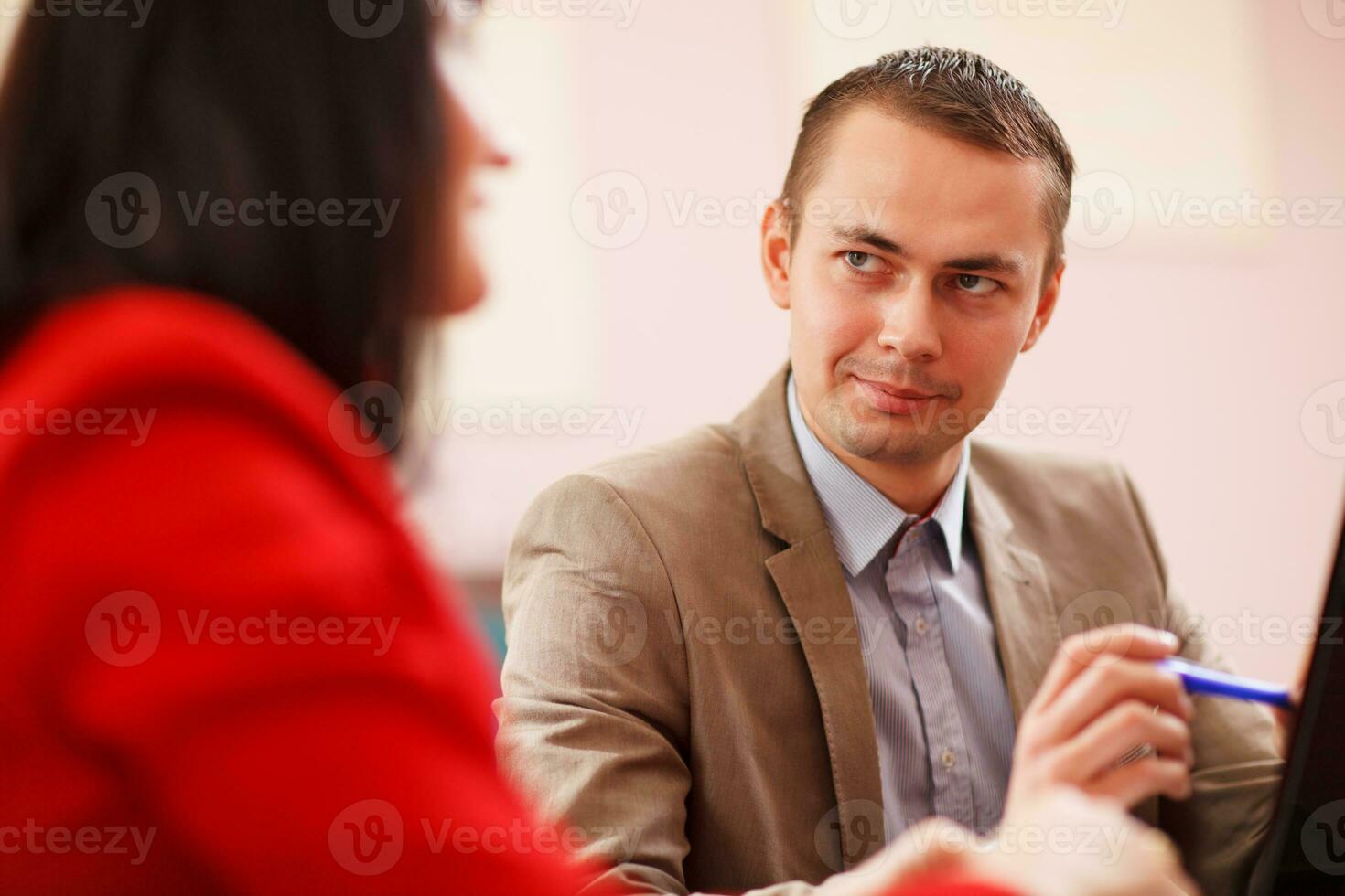 Smiling businessman consulting with a colleague photo