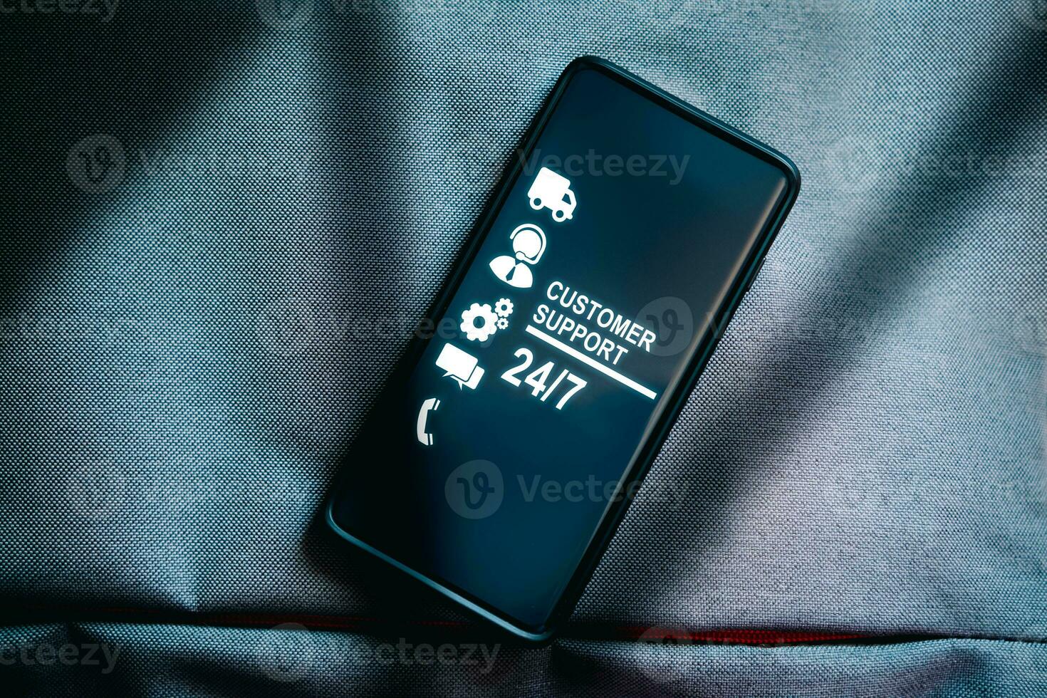 Top view of smartphone with nonstop and full time available service on screen. Assistance customer support hotline people connect. Feedback, business and finance concept. 24 hours concept. photo