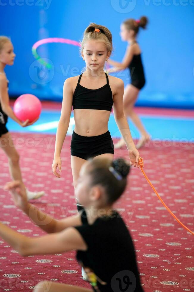 Girls exercising during gymnastics class photo