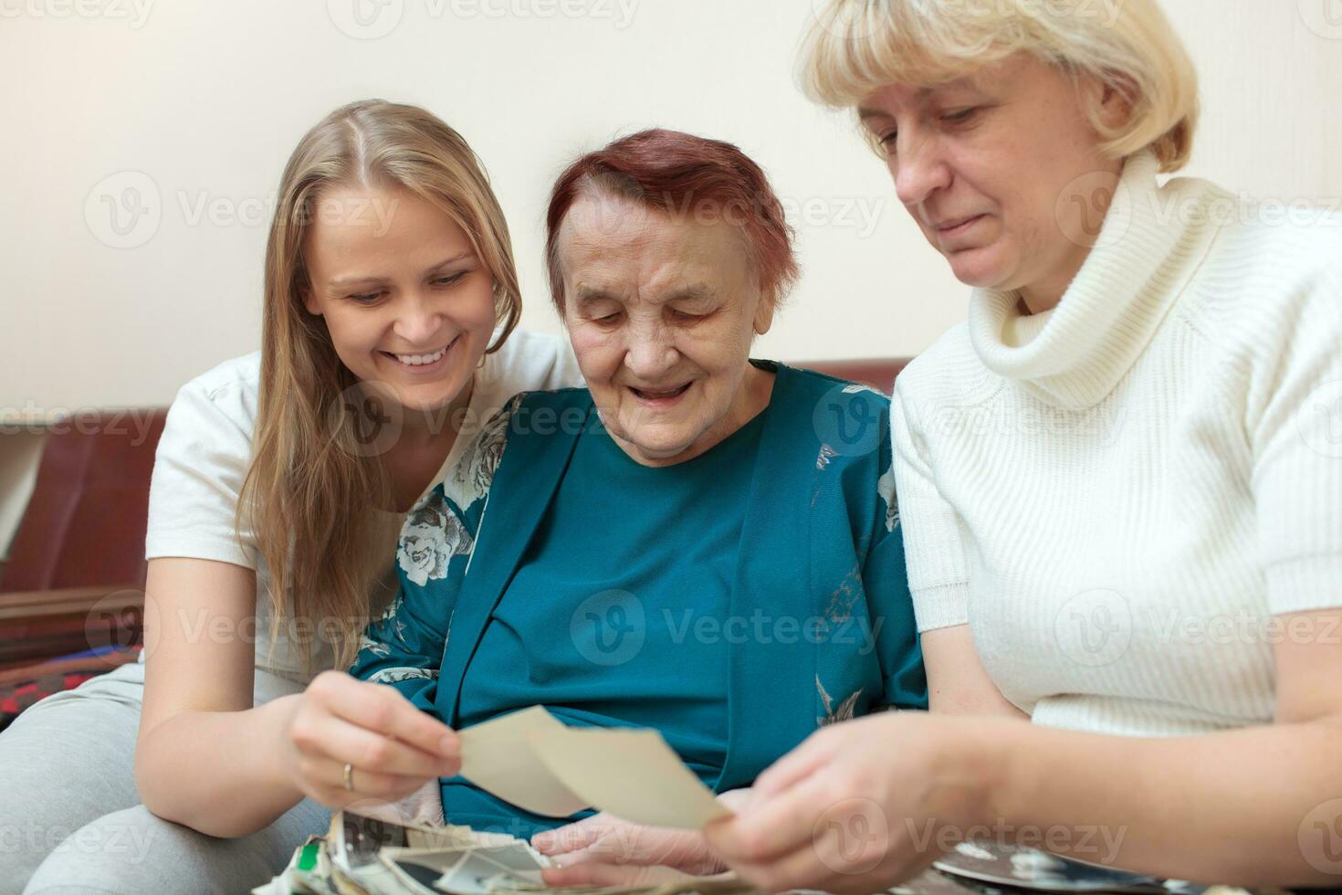 Mother, daughter and grandma looking at photos