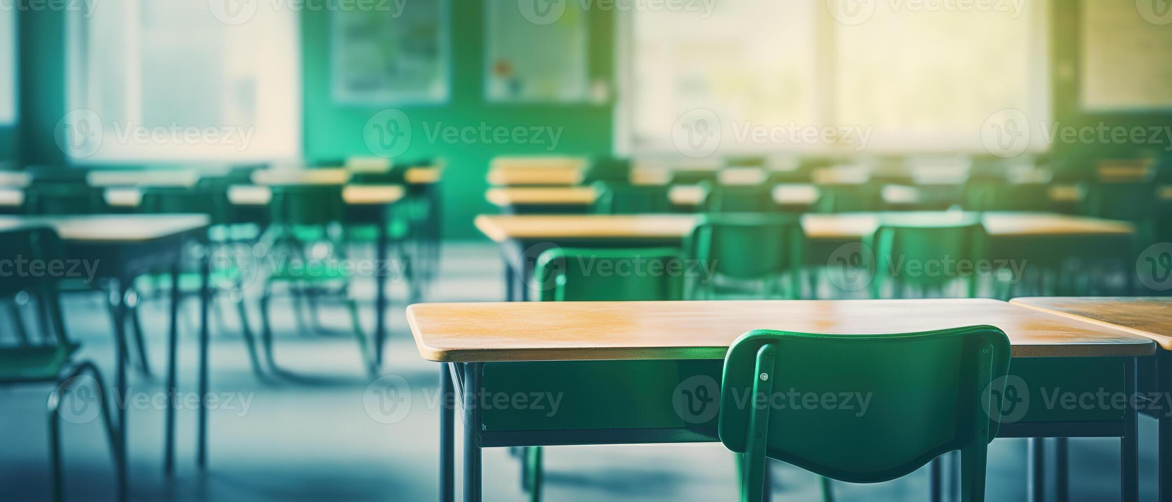 School classroom in blur background without young student. Blurry view of elementary class room no kid or teacher with chairs and tables in campus. Back to school concept. photo