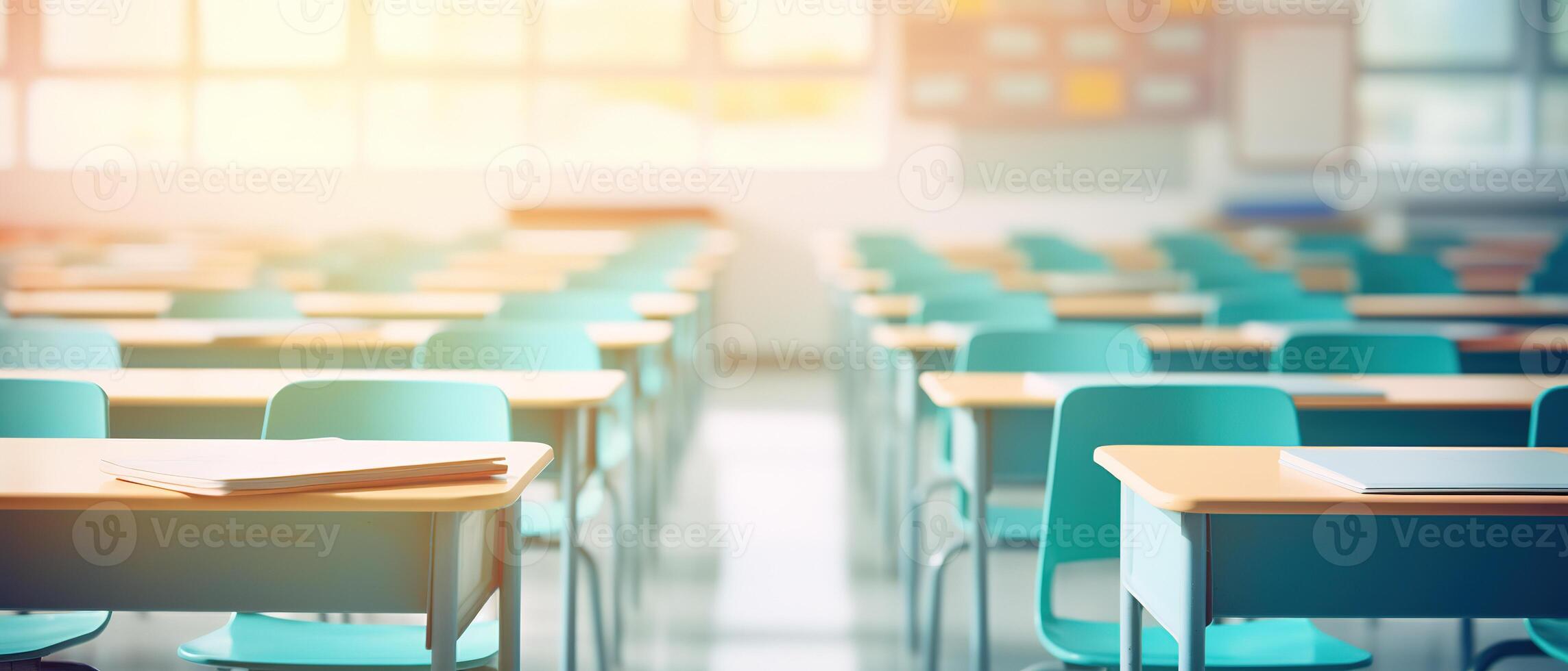 School classroom in blur background without young student. Blurry view of elementary class room no kid or teacher with chairs and tables in campus. Back to school concept. photo