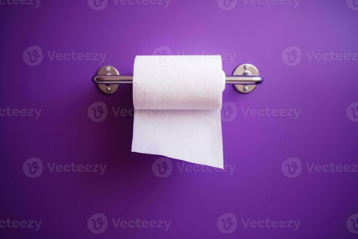 A white roll of soft toilet paper neatly hanging on a modern chrome holder. photo