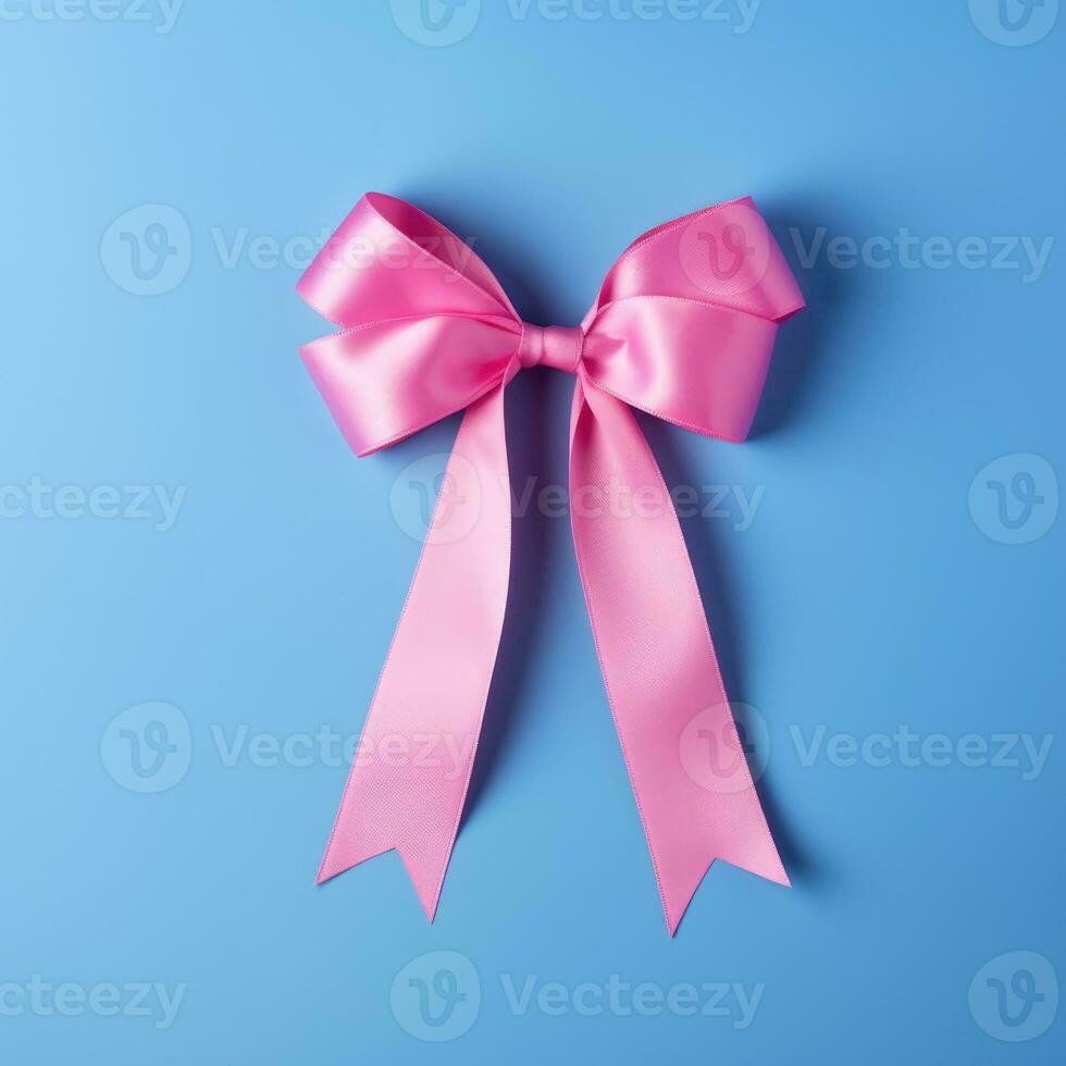 A pink ribbon on a blue background. Breast Cancer Month. photo