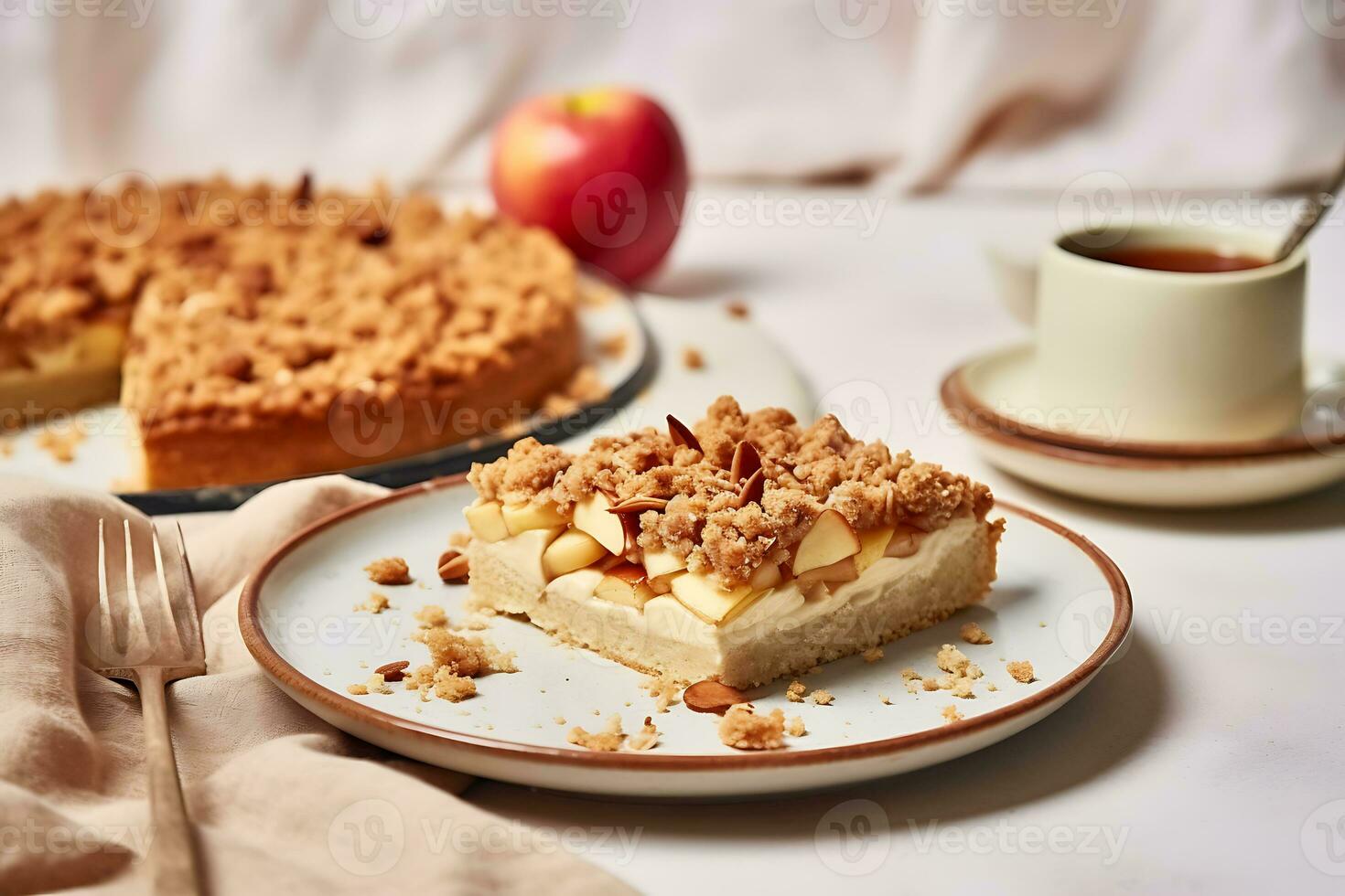 Homemade apple cake with crumble on a white table photo