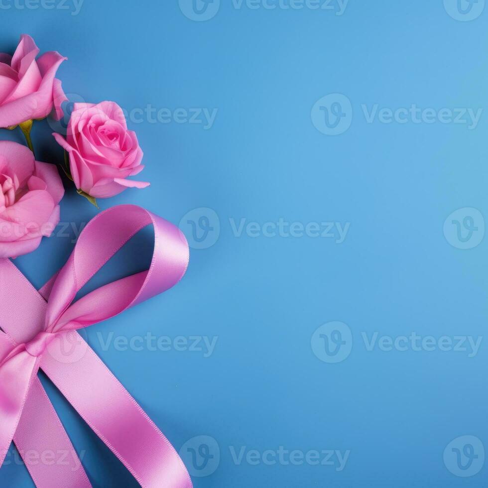 A pink ribbon on a blue background. Breast Cancer Month. photo