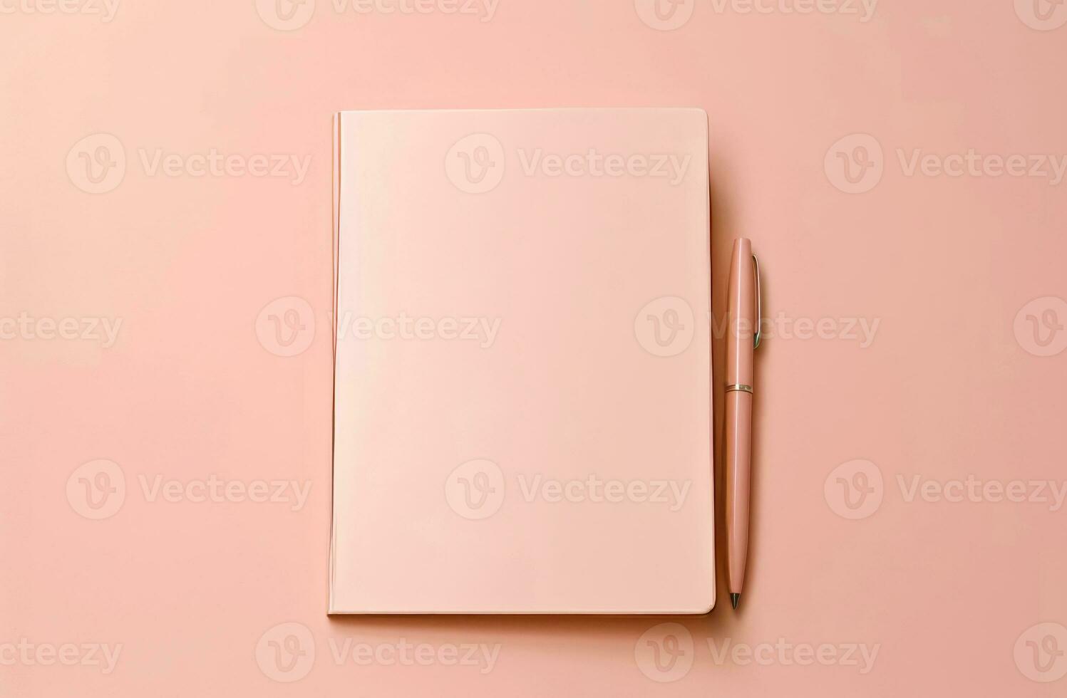 Notepad with blank pages and pen on a pink background. photo