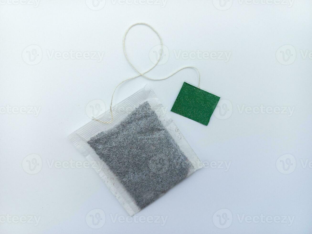 Tea Bag With Green Tag Isolated On White Background photo