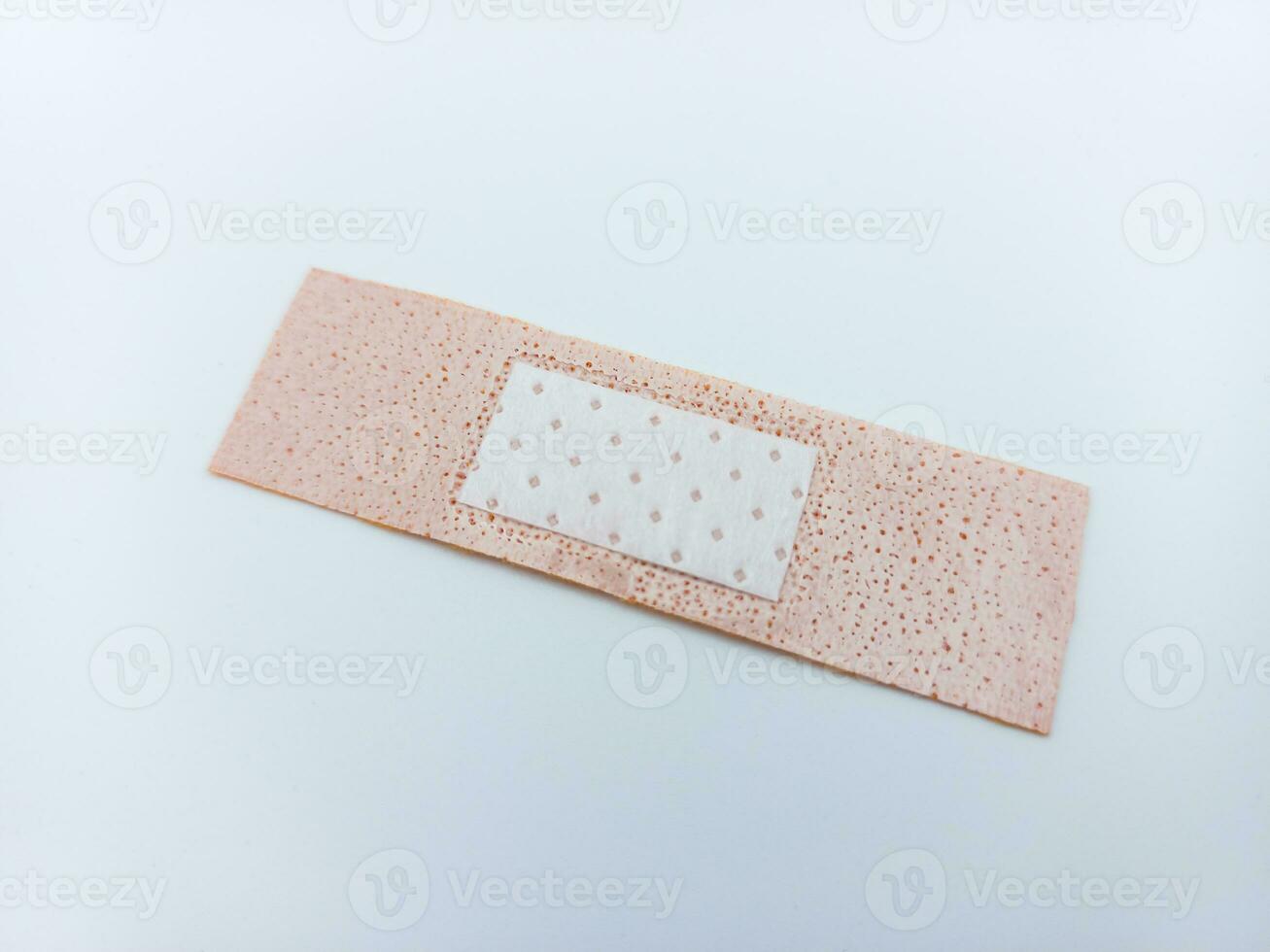 Small Size Adhesive Bandage Isolated On White Background. Tilted Inside View photo