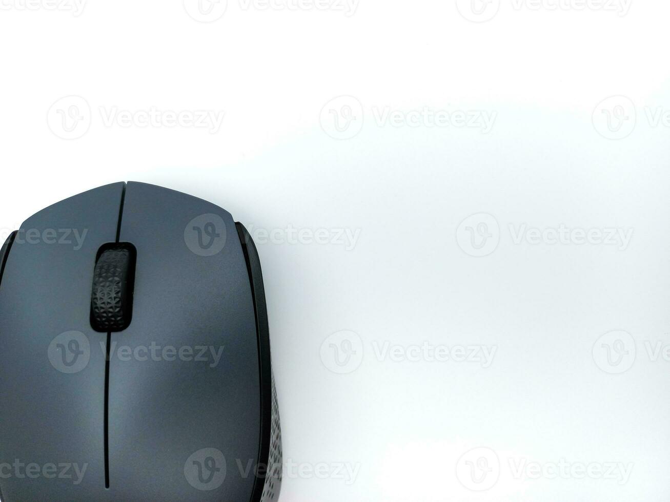 Black and Grey Wireless Computer Mouse Isolated On White Background. Corner With Negative Space photo