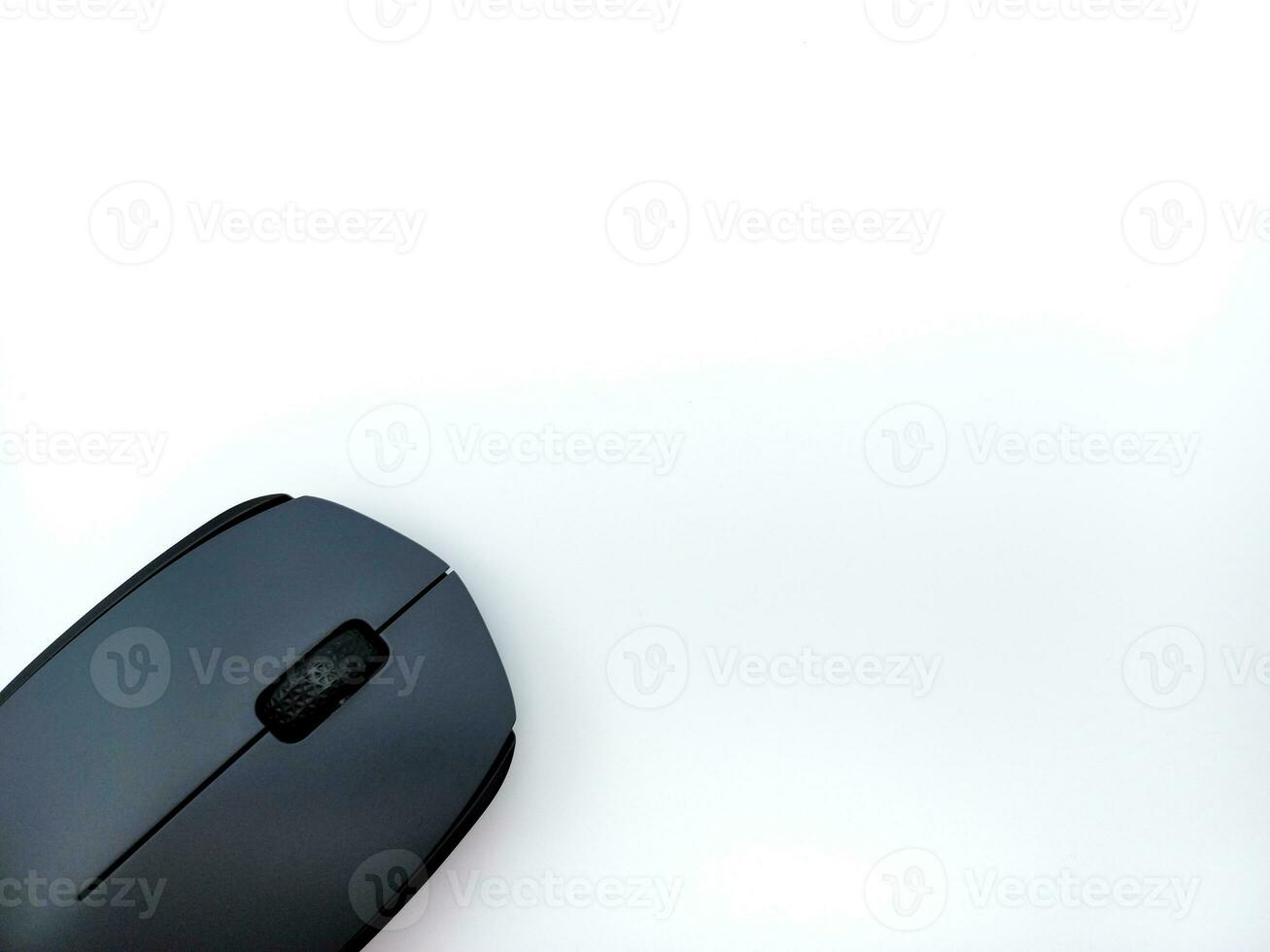 Black and Grey Wireless Computer Mouse Isolated On White Background. Corner Position With Negative Space photo