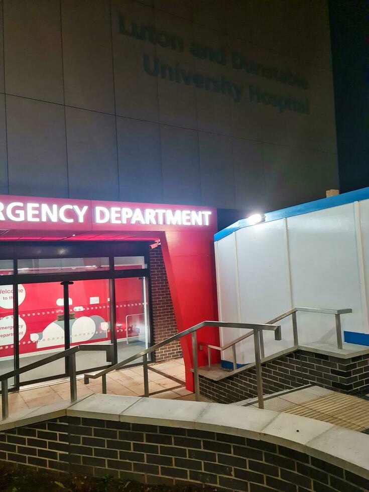 Low Angle Illuminated View of Emergency Entrance of Luton and Dunstable Hospital at Luton City of England UK During Midnight of Sep 3rd, 2023. Hospital's Building is Under construction for Renovation photo