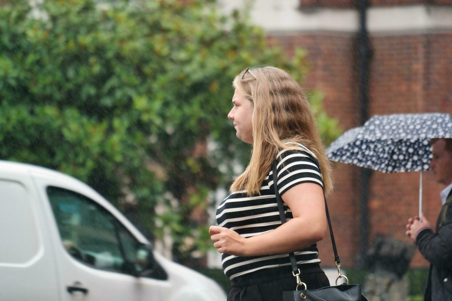 Beautiful Low Angle Image of People at Central London capital City of England Great Britain, Most of the Tourist are International from Many Communities of World. Image Captured on August 2nd, 2023 photo