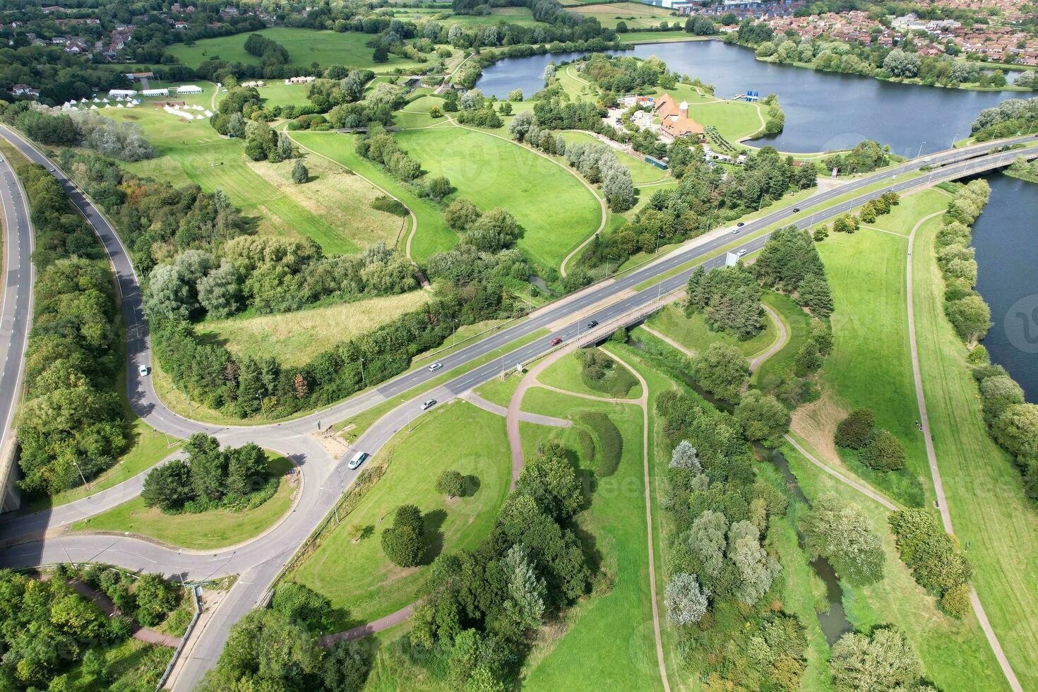 High Angle Footage of British Road and Traffic at Caldecotte Lake of Milton Keynes City of England Great Britain, Beautiful View Captured on August 21st, 2023 with Drone's Camera During Sunny Day photo
