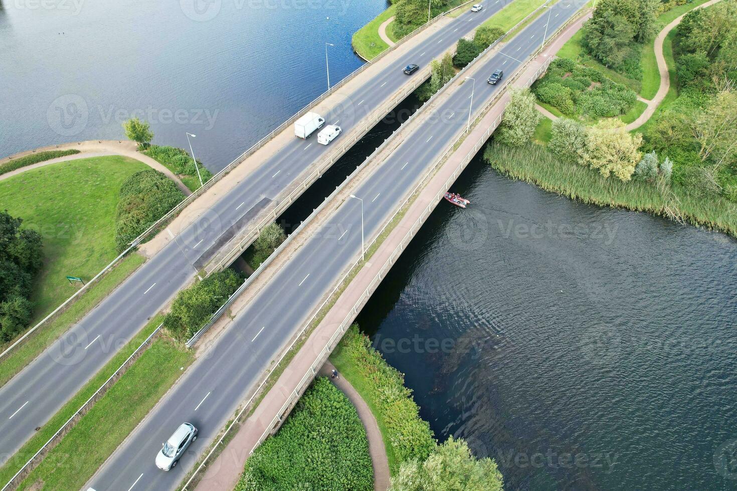 High Angle Footage of British Road and Traffic at Caldecotte Lake of Milton Keynes City of England Great Britain, Beautiful View Captured on August 21st, 2023 with Drone's Camera During Sunny Day photo