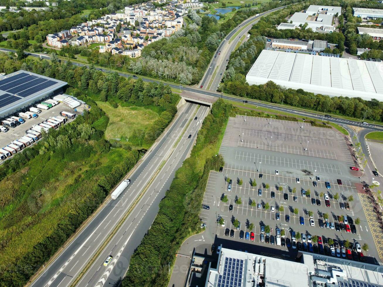 High Angle Footage of British Road and Traffic at Caldecotte Lake of Milton Keynes City of England Great Britain, Beautiful View Captured on August 21st, 2023 with Drone's Camera During Sunny Day photo