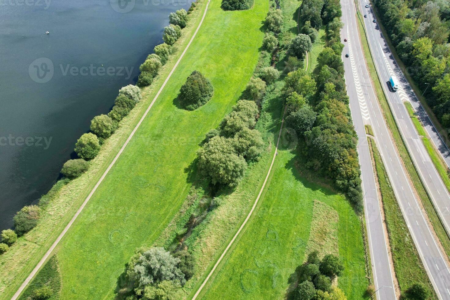 High Angle Footage of British Road and Traffic at Caldecotte Lake of Milton Keynes City of England Great Britain, Beautiful View Captured on August 21st, 2023 with Drone's Camera During Sunny Day photo