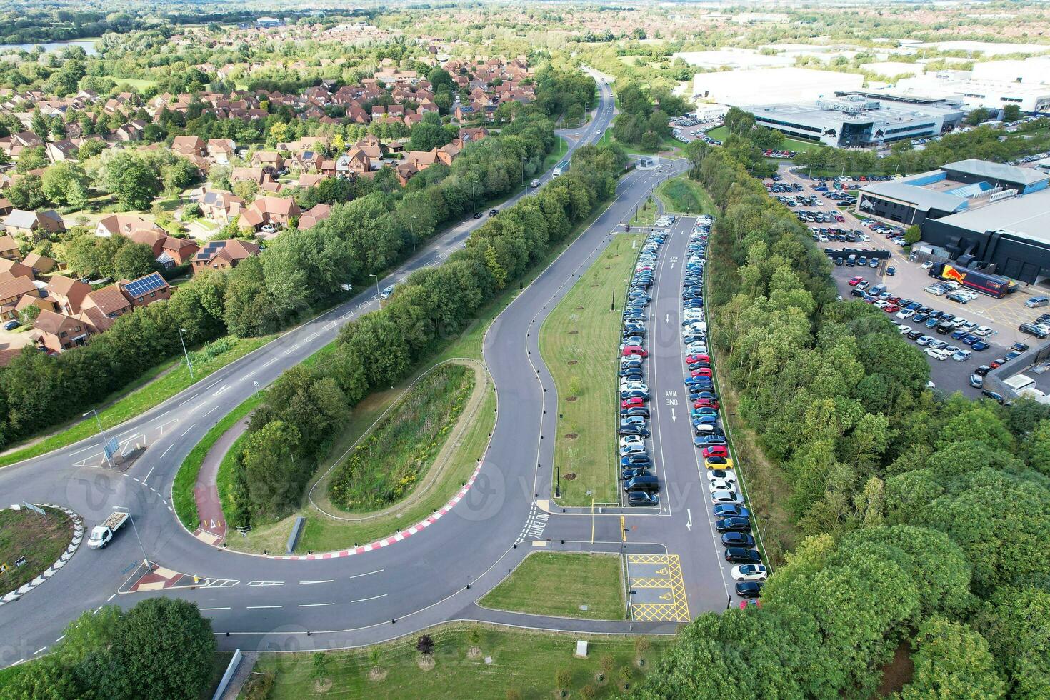 High Angle Footage of British Road and Traffic at Caldecotte Lake of Milton Keynes City of England Great Britain, Beautiful View Captured on August 21st, 2023 with Drone's Camera During Sunny Day photo