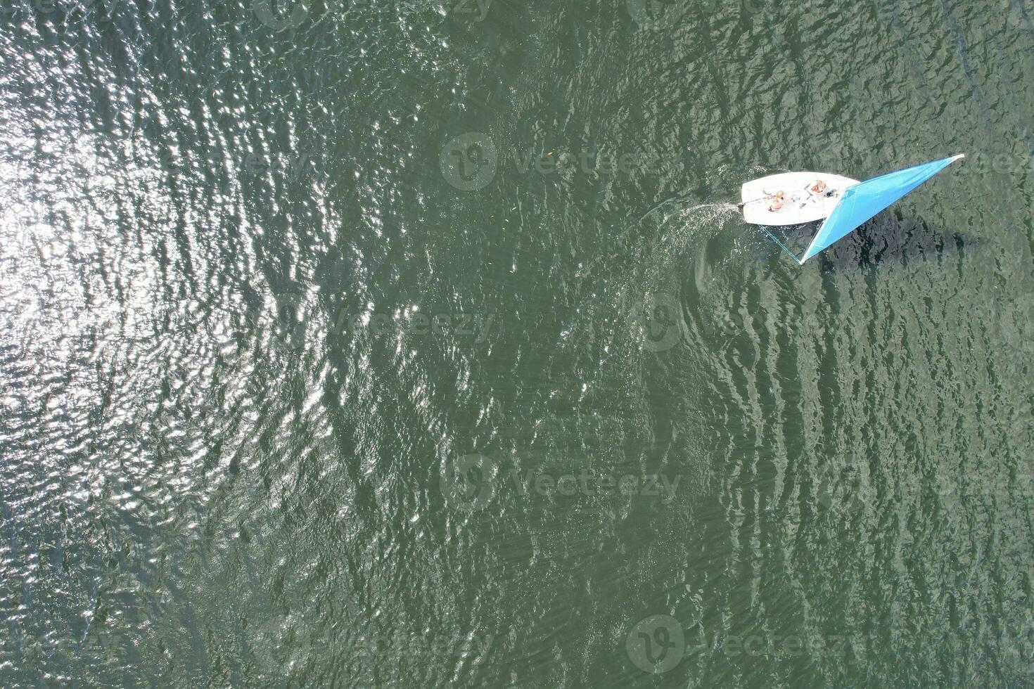 High Angle footage of People are Boating at Caldecotte Lake Located at Milton Keynes City of England Great Britain UK. The Aerial Landscape Was Captured on August 21st, 2023 with Drone's Camera photo