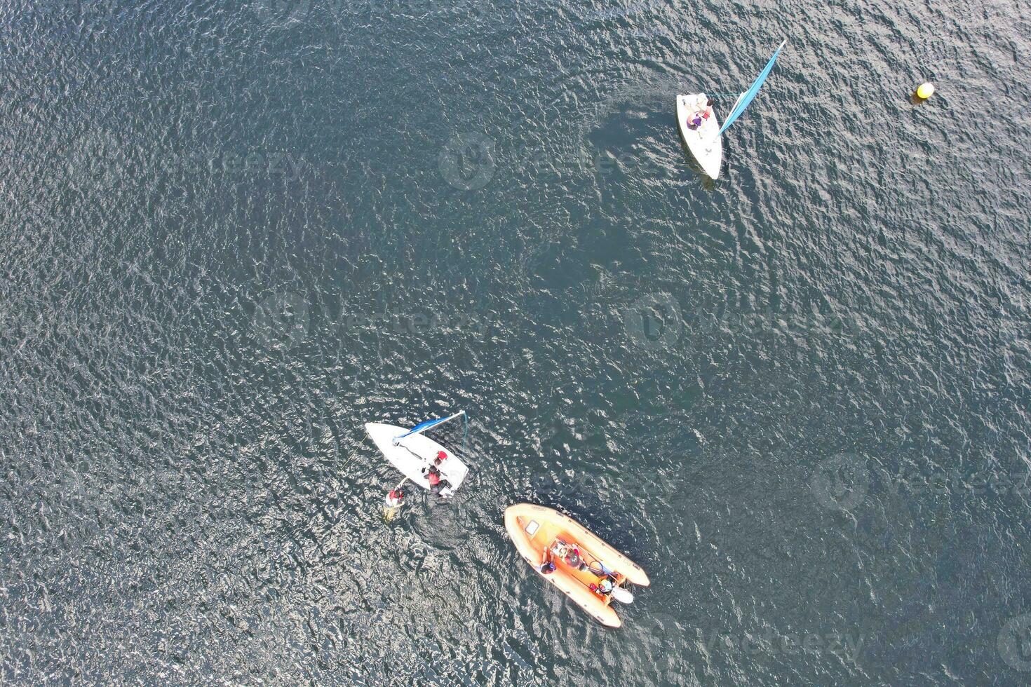 High Angle footage of People are Boating at Caldecotte Lake Located at Milton Keynes City of England Great Britain UK. The Aerial Landscape Was Captured on August 21st, 2023 with Drone's Camera photo