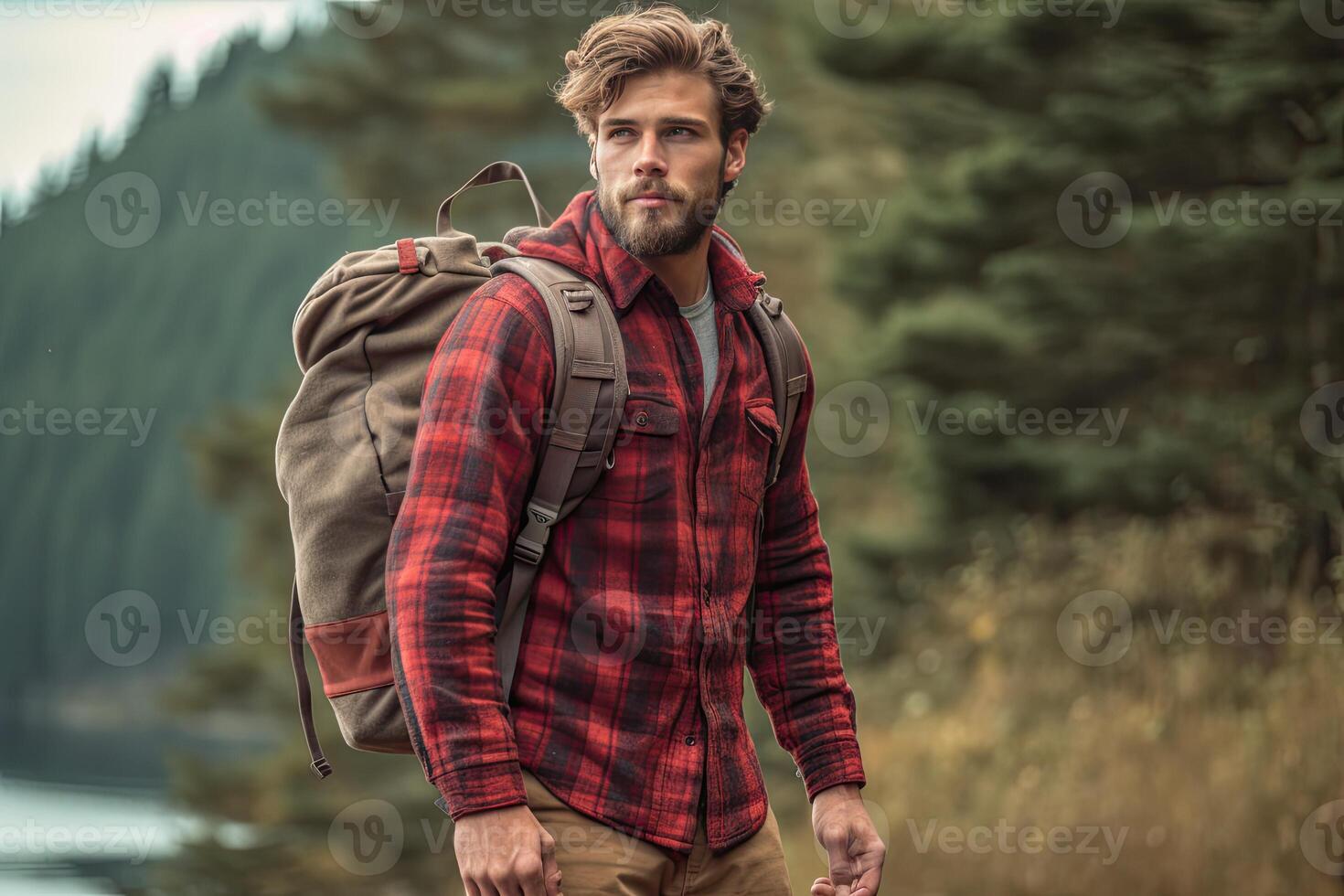 Handsome bearded man with backpack in the autumn forest. Travel and adventure concept. photo