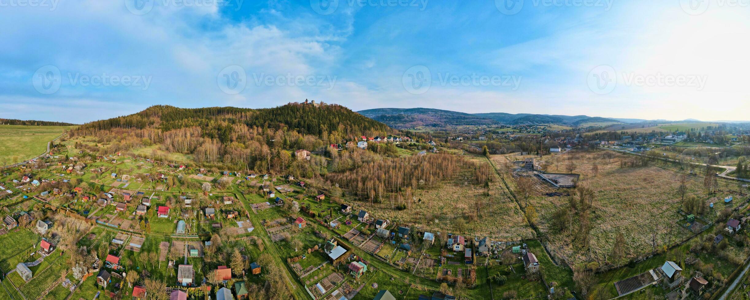 Mountain village among green fields, aerial view. photo