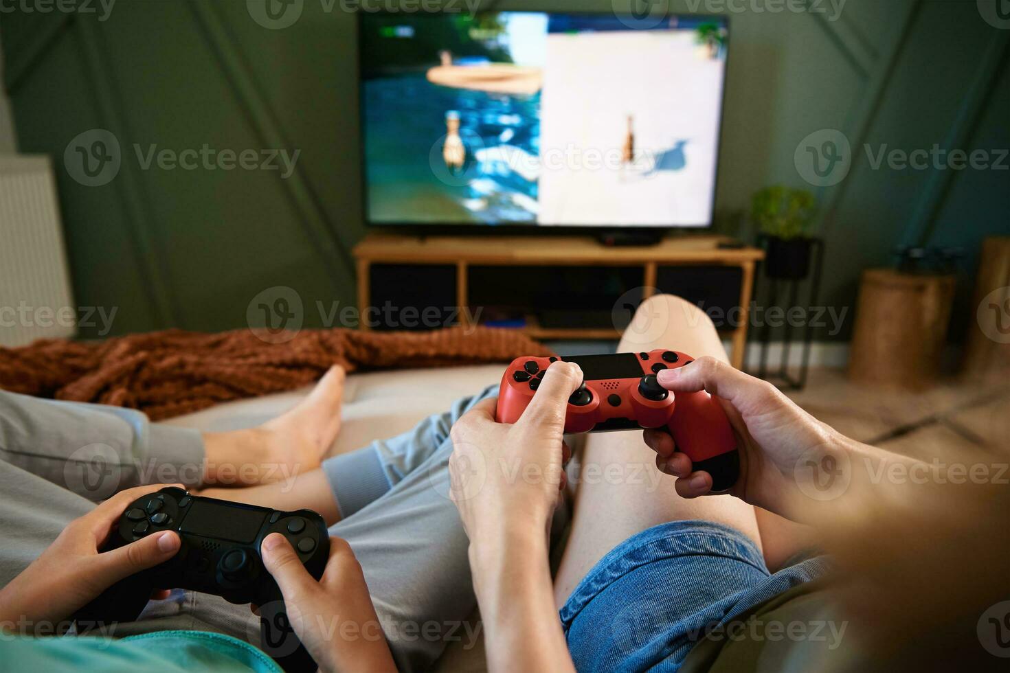 Boy and man playing video game at home photo