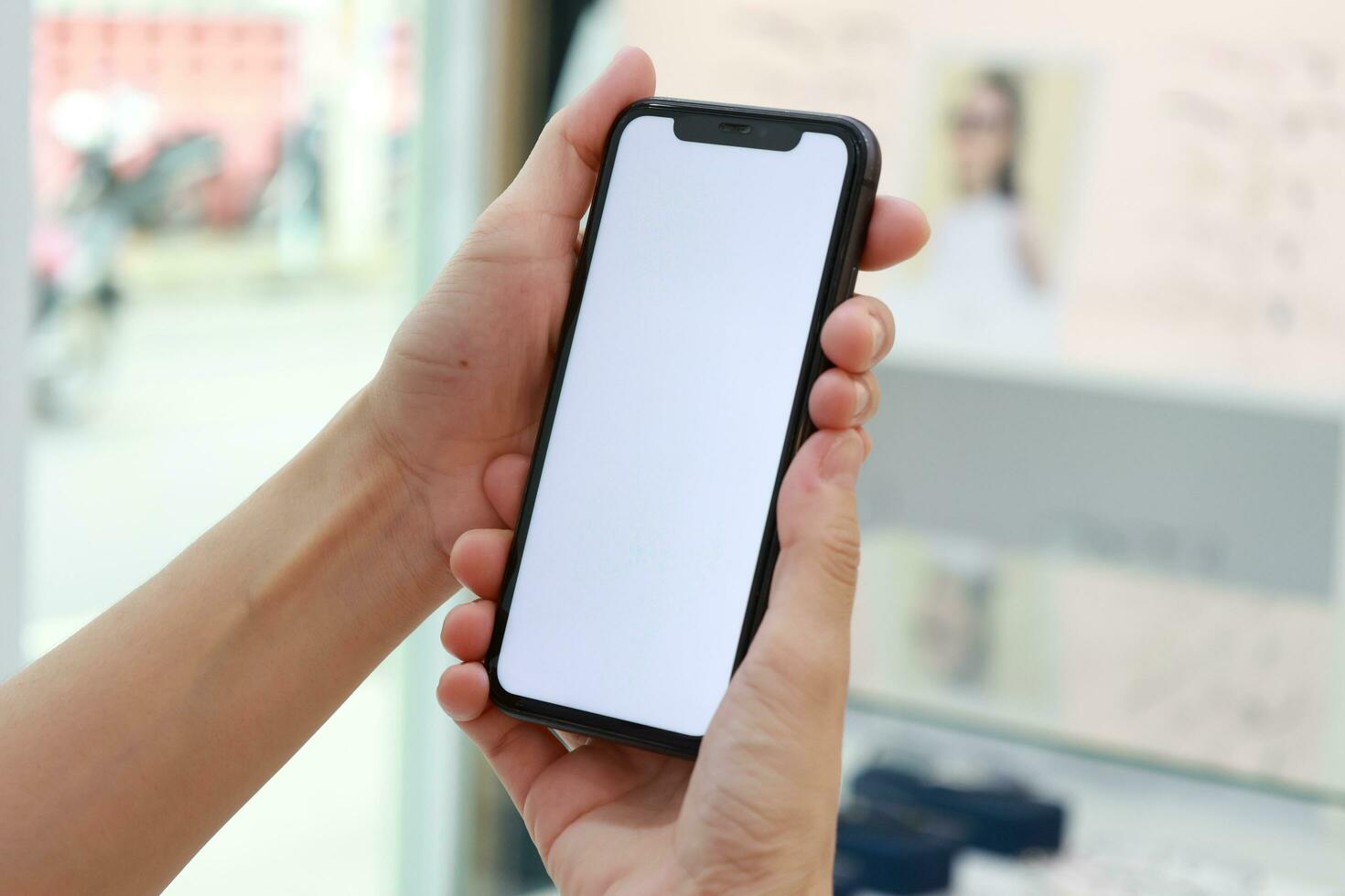 Hand holding phone white screen, mobile phone white screen photo