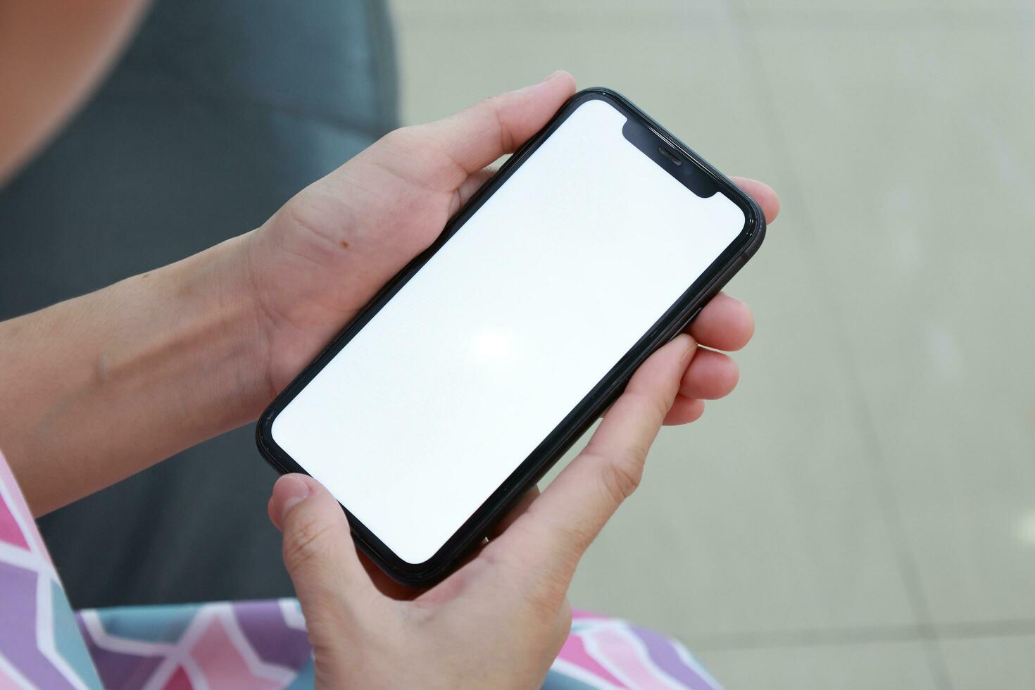 Hand holding phone white screen, mobile phone white screen photo