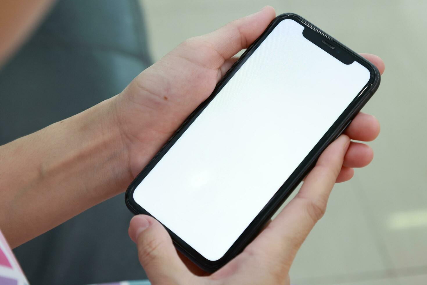 Hand holding phone white screen, mobile phone white screen photo