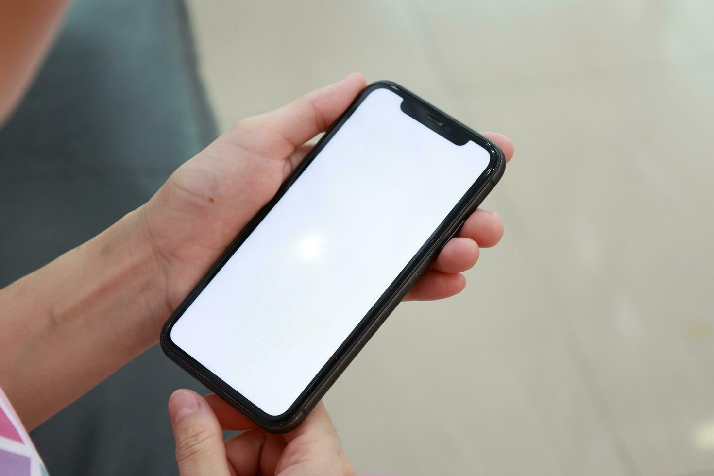 Hand holding phone white screen, mobile phone white screen photo