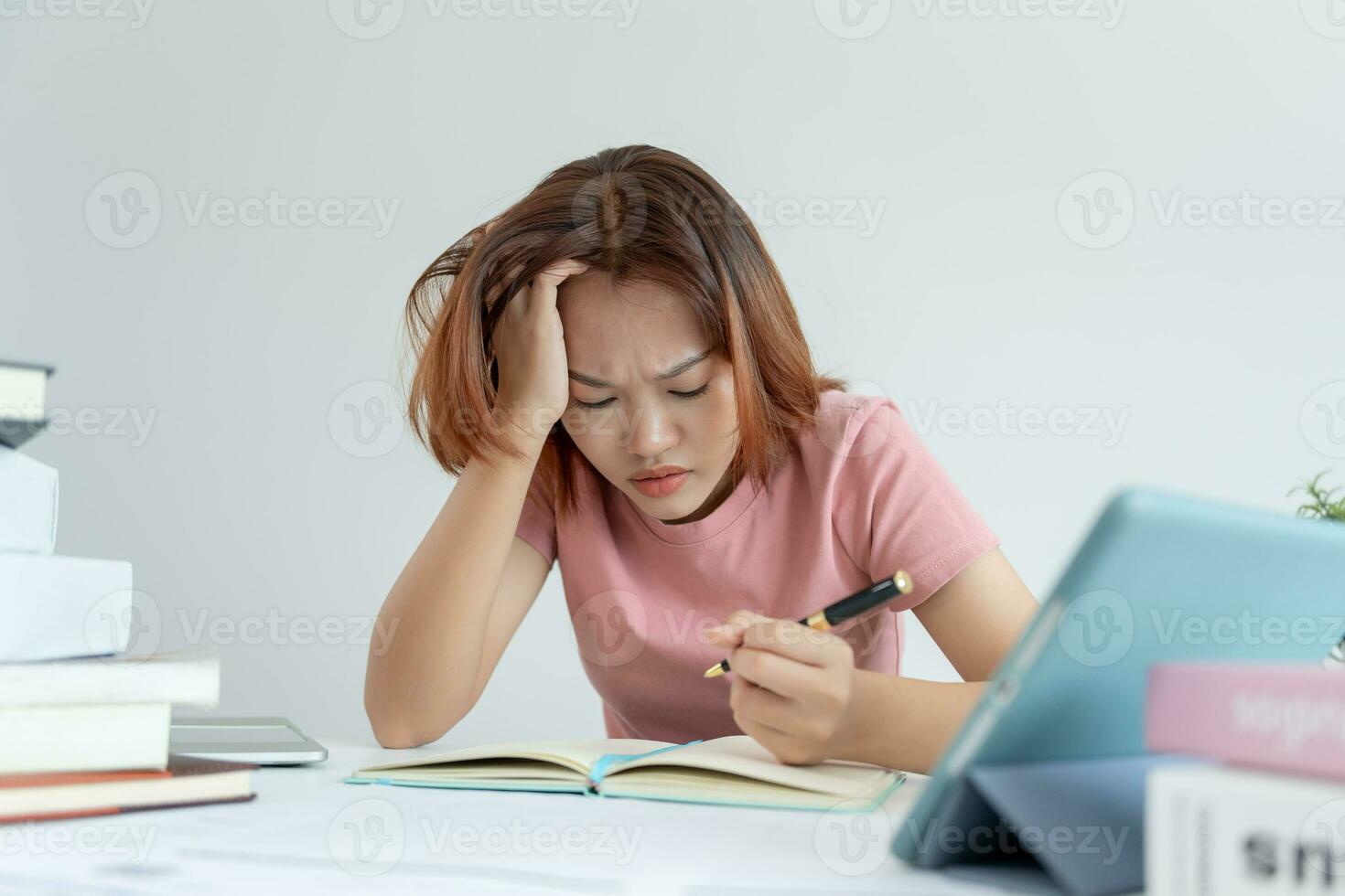 Asian student woman have anxiety because of exams, female prepare for test and learning lessons in the library. stress, despair, haste, misunderstanding reading, discouraged, expectation, knowledge photo