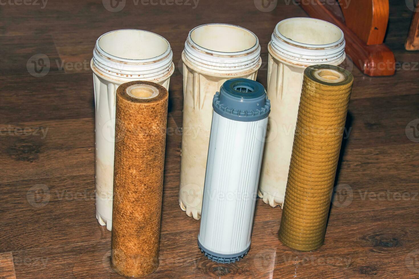 Used water filters with traces of dirt, clay and impurities. Replacing multi-stage water filter cartridges. photo