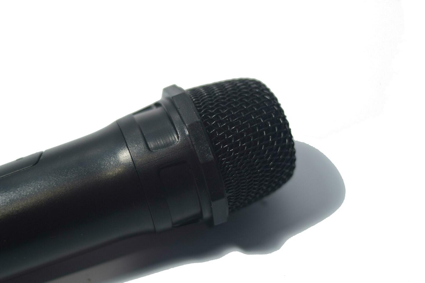 Close up black microphone isolated on white background photo