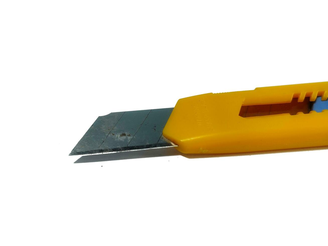 Cutter blade with yellow handle isolated on white background. Sharper object to cut paper photo