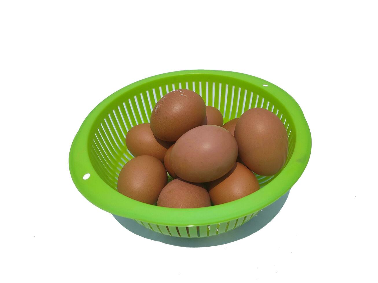 A group of eggs in green basket isolated on white background photo