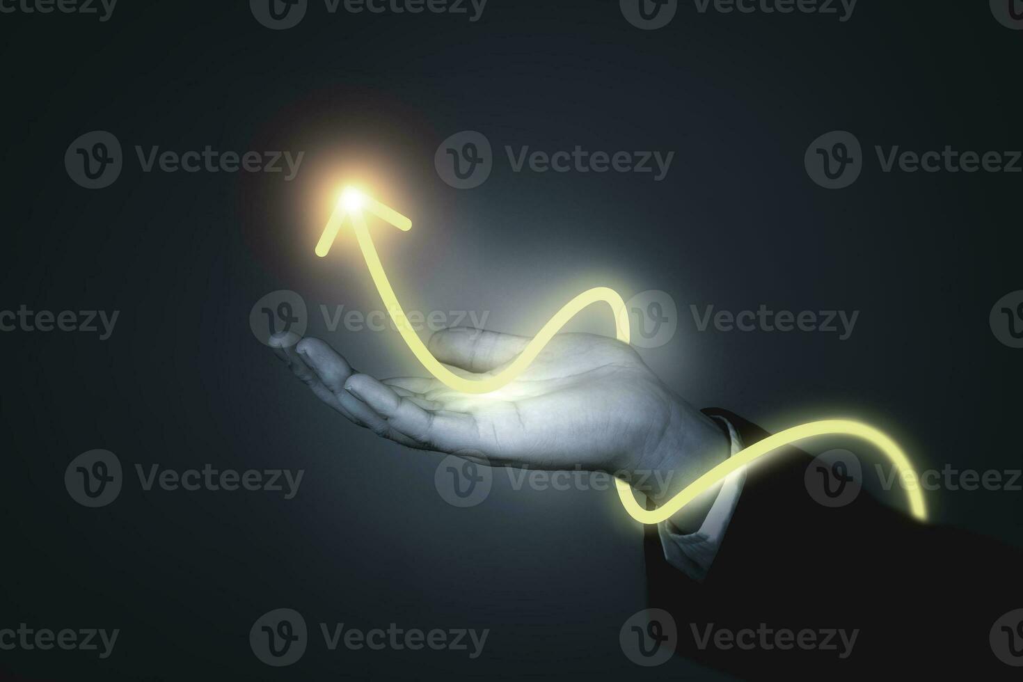 Businessman's hand showing rising arrow on dark background. concepts of business that express the development or increasing business opportunities and more profits photo