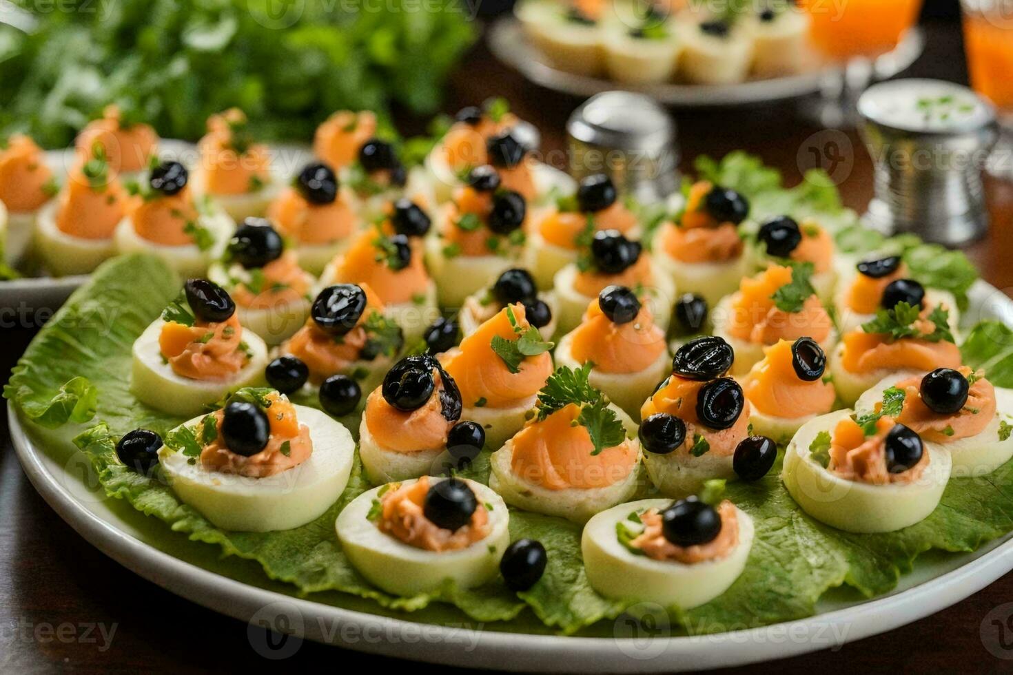 a stunning platter of appetizers on a silver platter, placed on a pristine white tablecloth. photo