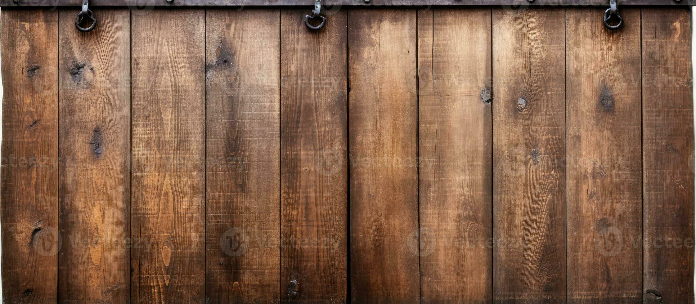 Closeup of a vintage double barn door with wooden texture and metallic handle and bolts seen from the front photo