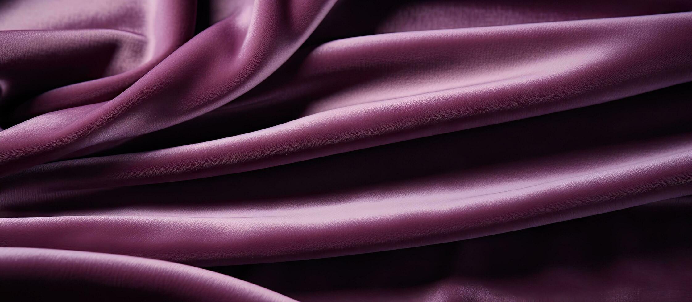 Sample of velour fabric in a plum color with a textured background photo