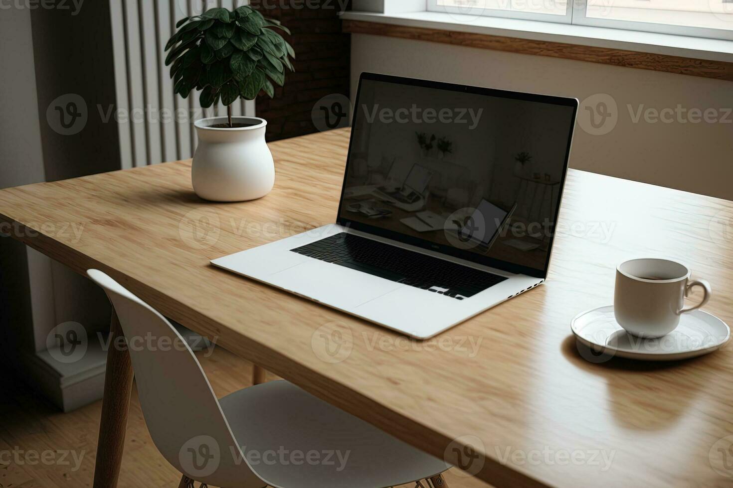 a mockup laptop with a white screen and a wooden table in a shared workspace photo