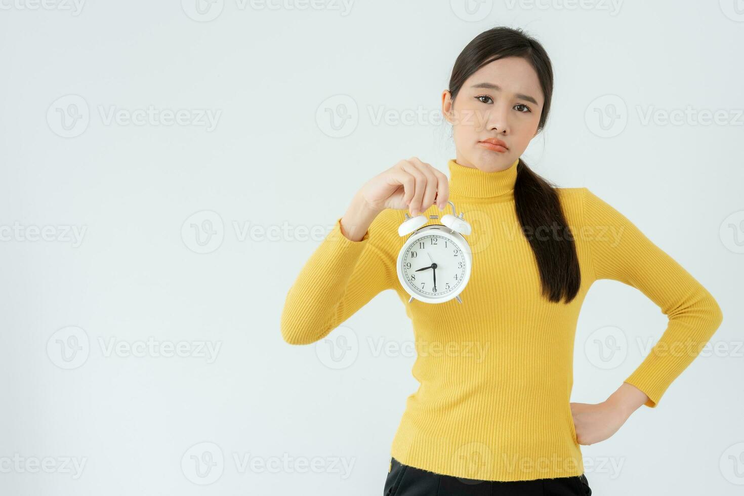 Stress Asia young woman show clock alarm, lady is late appointment or work or class study, overslept, difficulty get up in mornings, time worried, not on time, sleepy, over due, Hurry up time photo