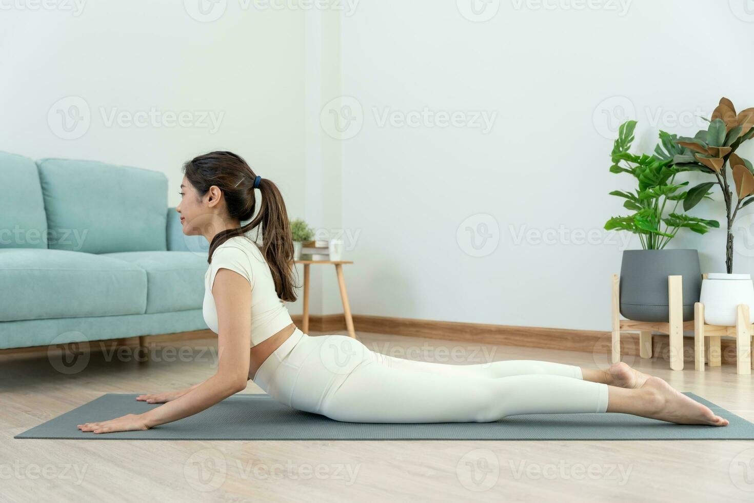 Slim woman practicing yoga on room of her condo or home. Asian woman doing exercises in morning. balance, meditation, relaxation, calm, good health, happy, relax, healthy lifestyle, diet, slim photo