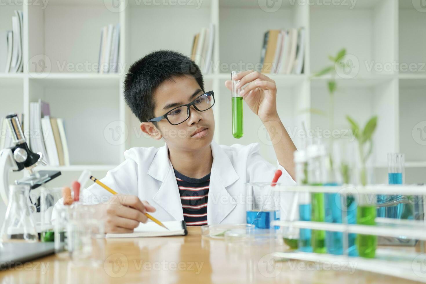 Young Scientists in Action Kids Conduct Chemistry Experiment in School Laboratory photo