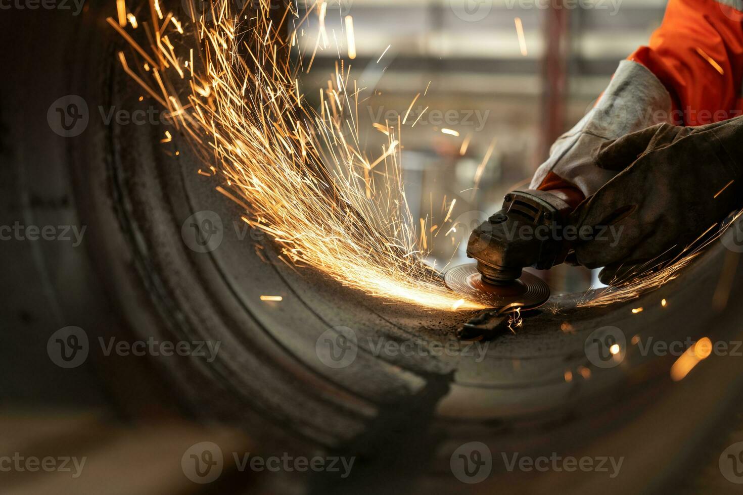 Close-up of Electric wheel grinding at Industrial worker cutting metal pipe with many sharp sparks photo